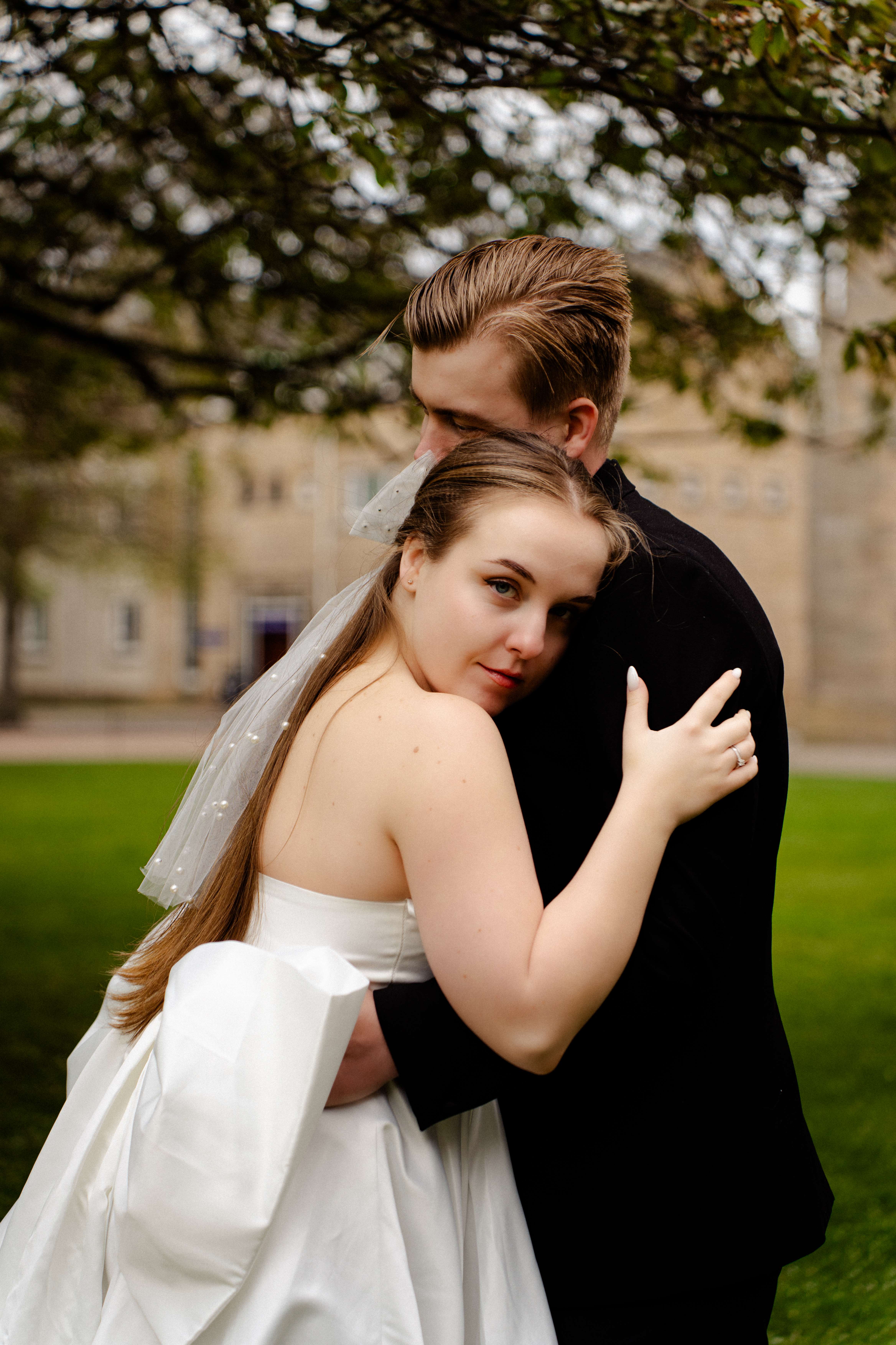 Newlywed couple embracing outdoors