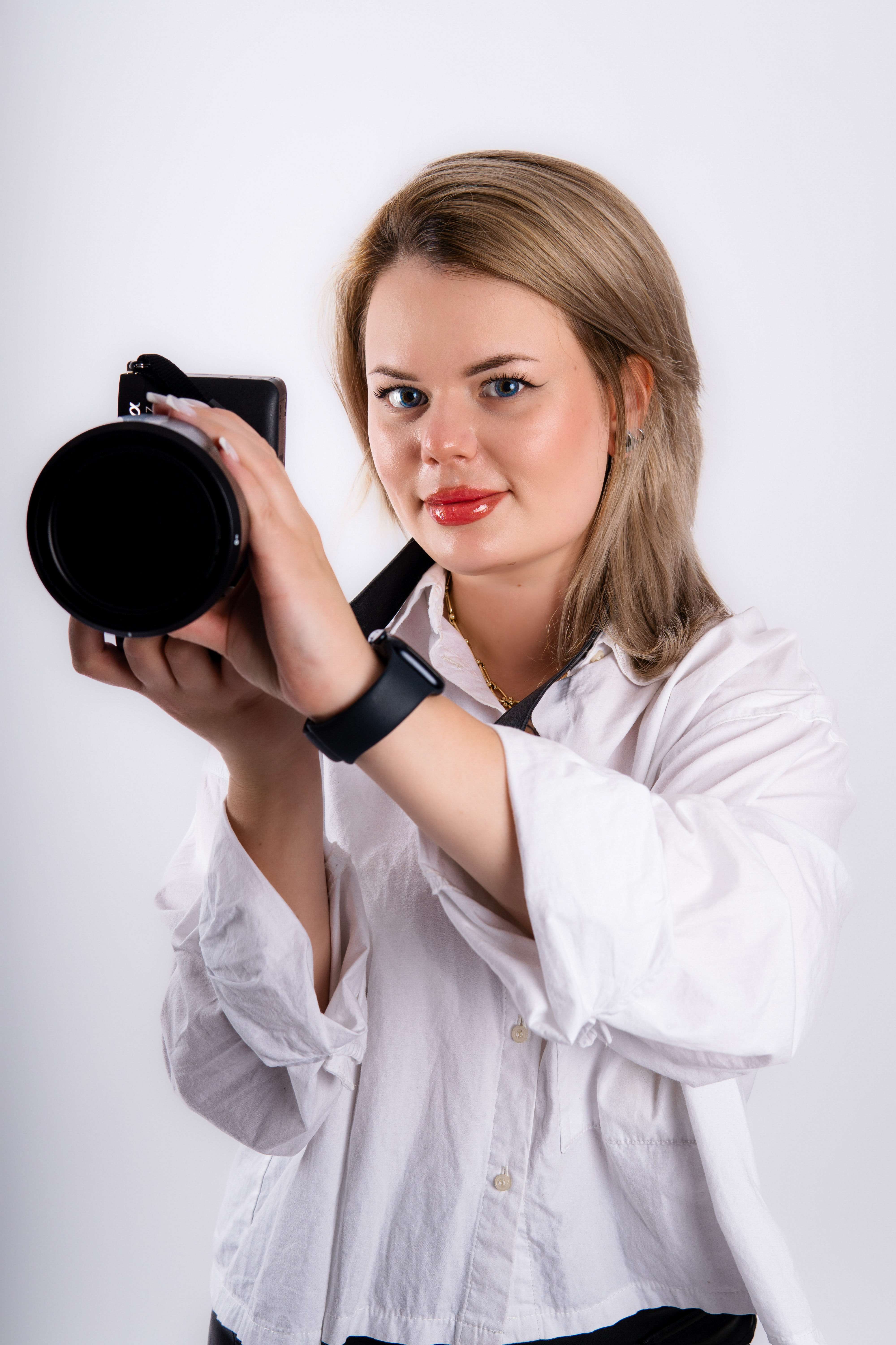 Portrait of Liza German holding her camera